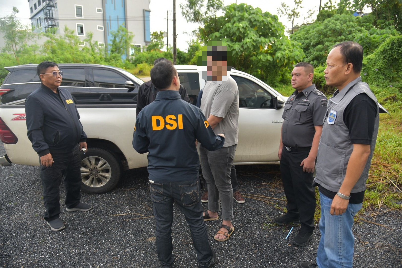 Officials gathered beside a vehicle during an investigation