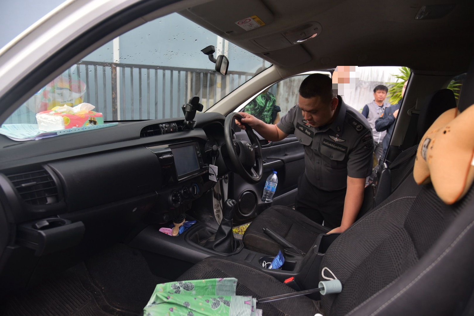 An officer searches the interior of a vehicle